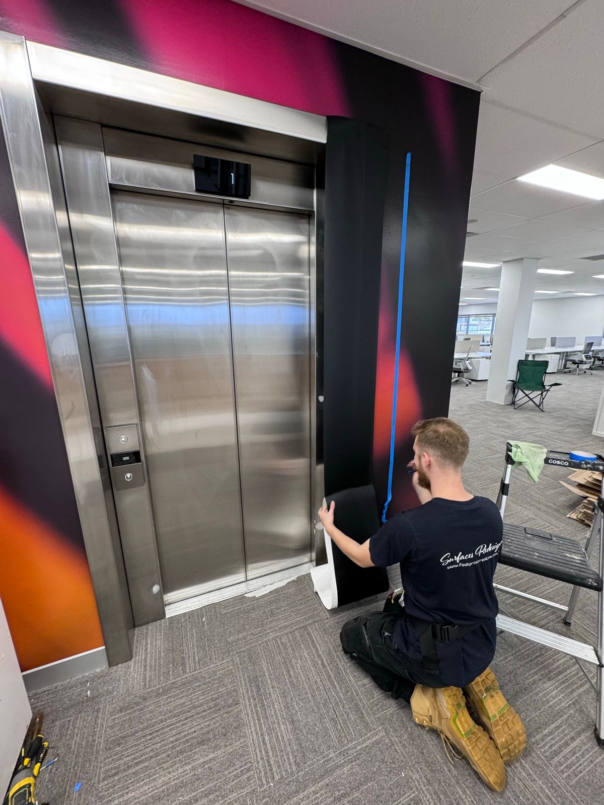 Installation in progress: Lift doors and frame, stainless to matte black