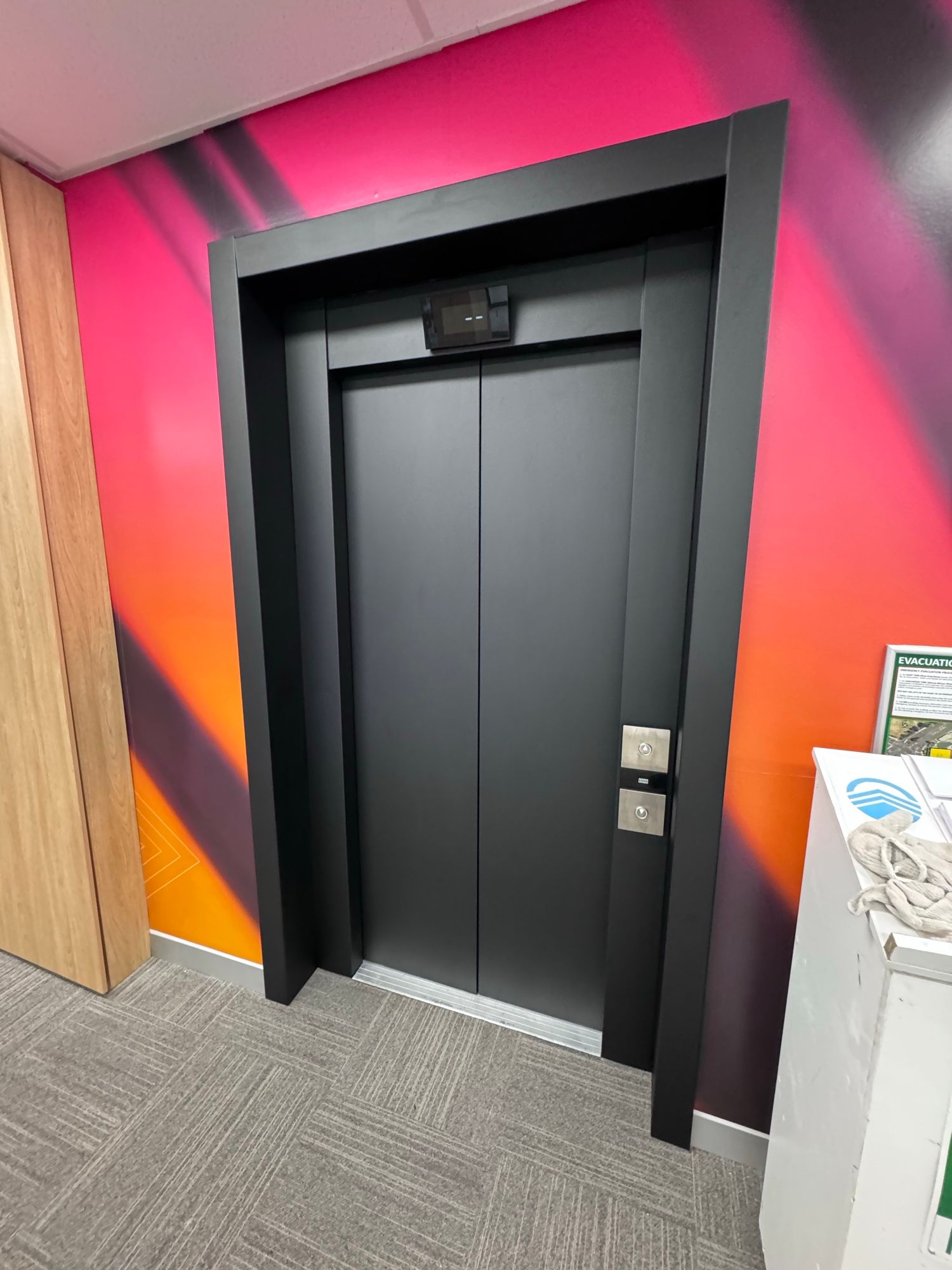 After: Lift doors and frame, stainless to matte black