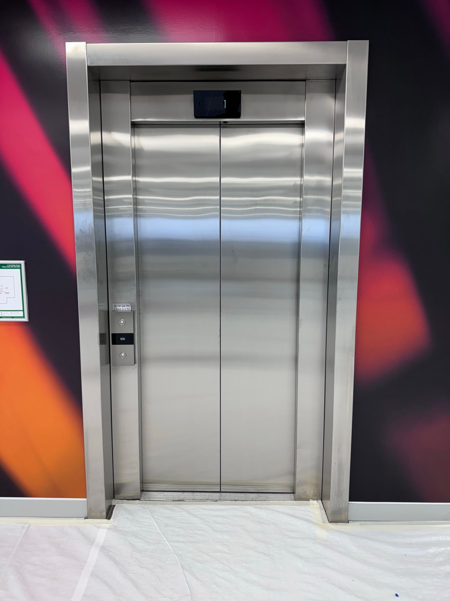 Before: Lift doors and frame, stainless to matte black