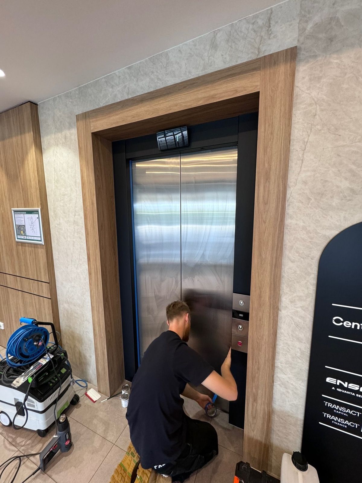Installation in progress: Lobby lift doors, stainless to matte black
