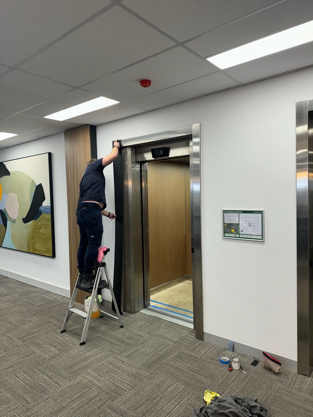 Installation in progress: Lift doors and surround, stainless to matte black