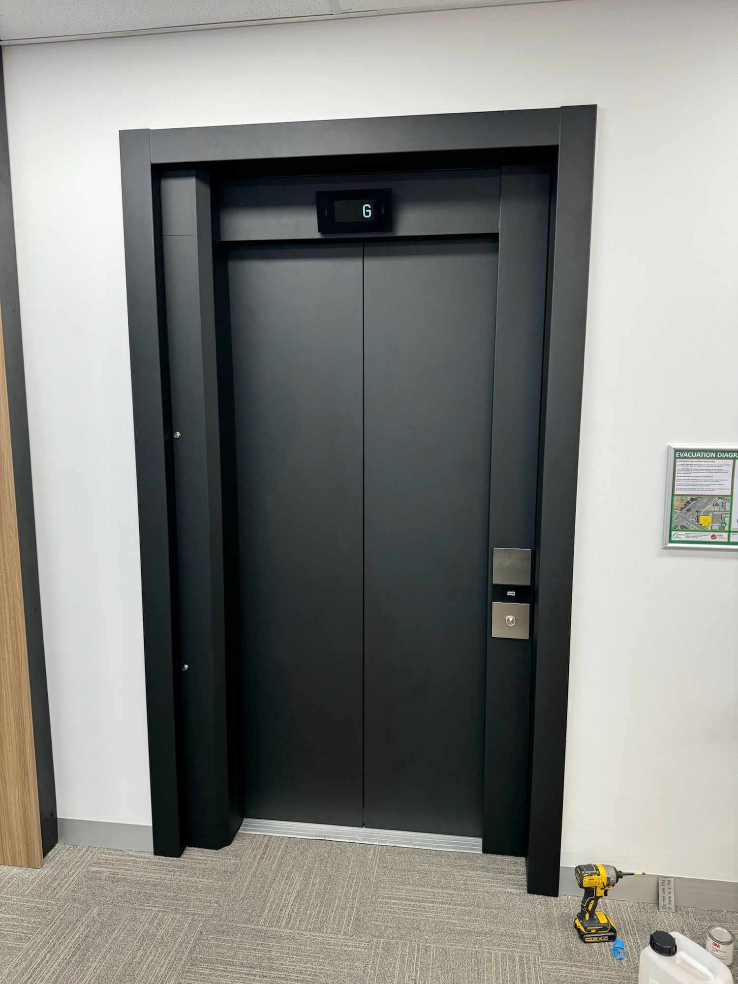 After: Lift doors and surround, stainless to matte black
