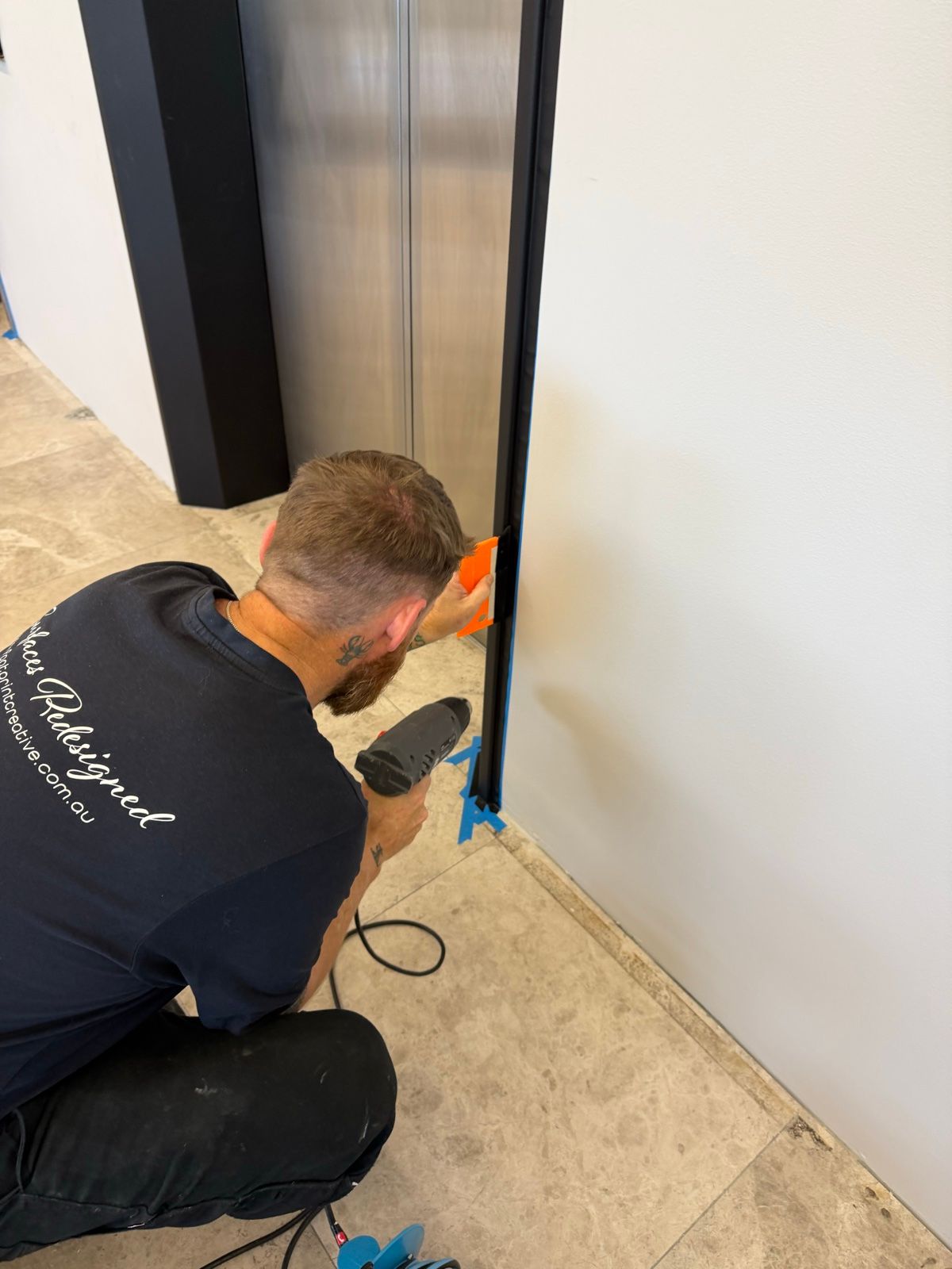 Installation in progress: Lift lobby, four sets of doors in matte black