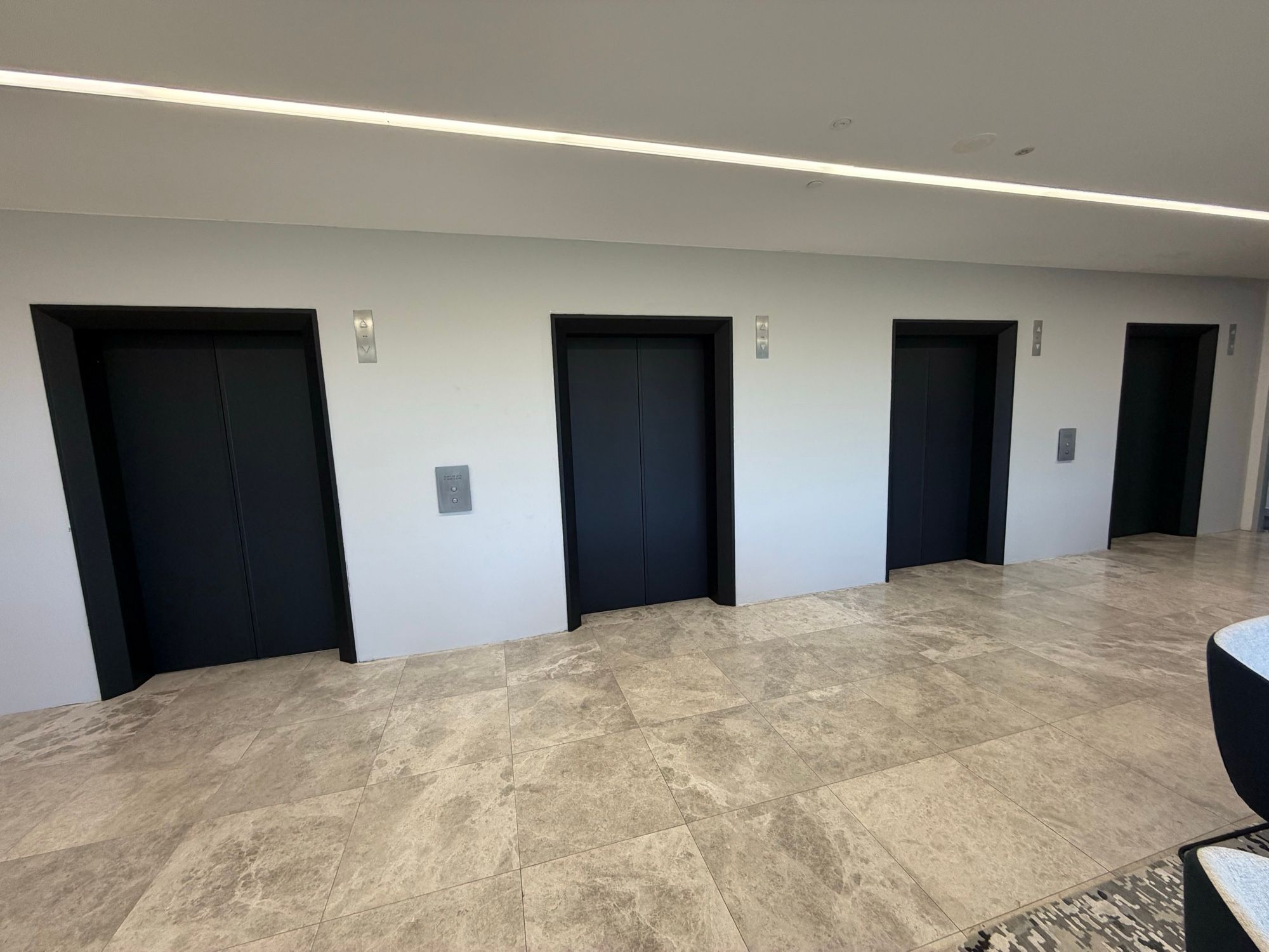 After: Lift lobby, four sets of doors in matte black
