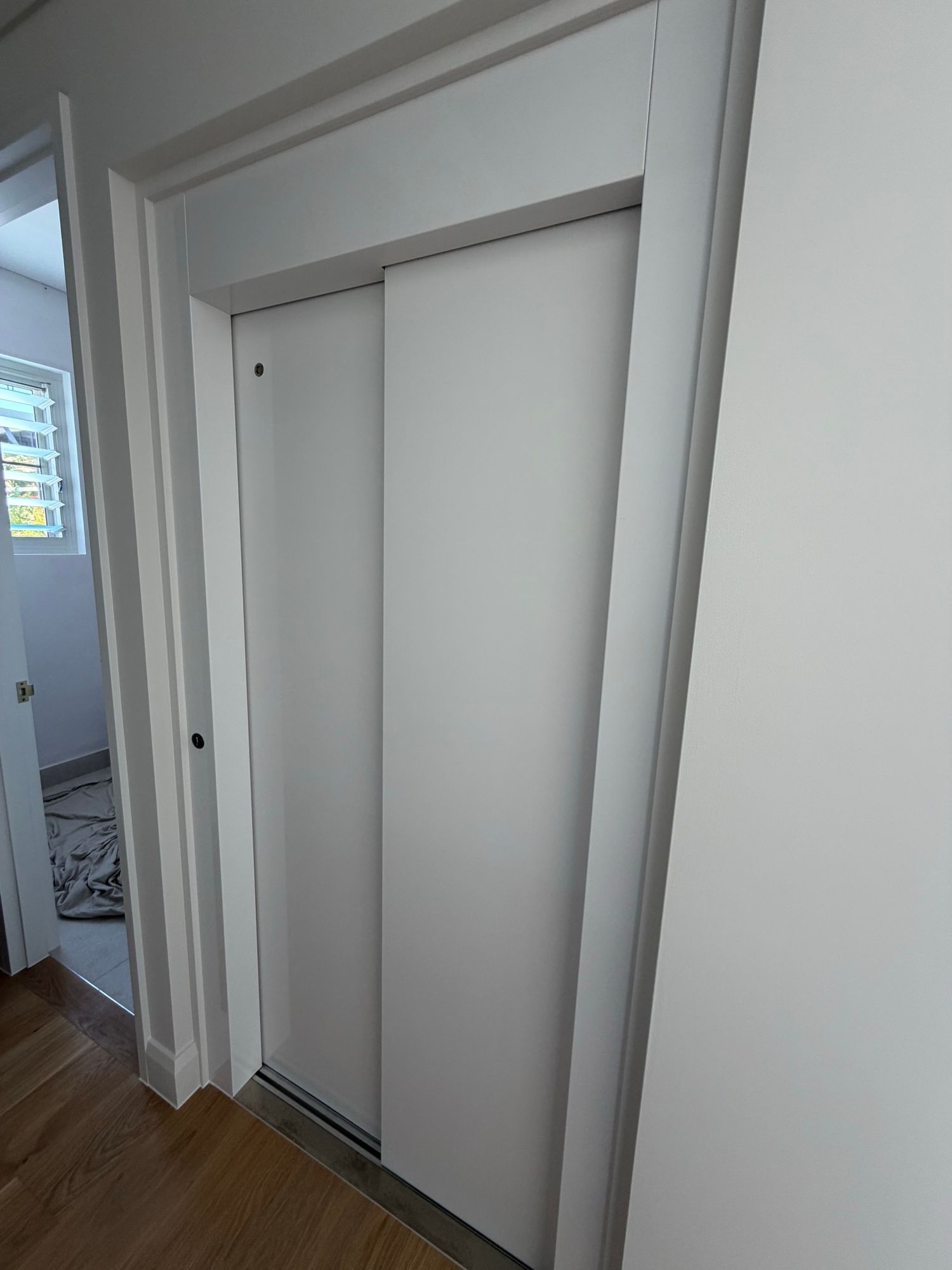 Before: Home lift doors, white to light woodgrain