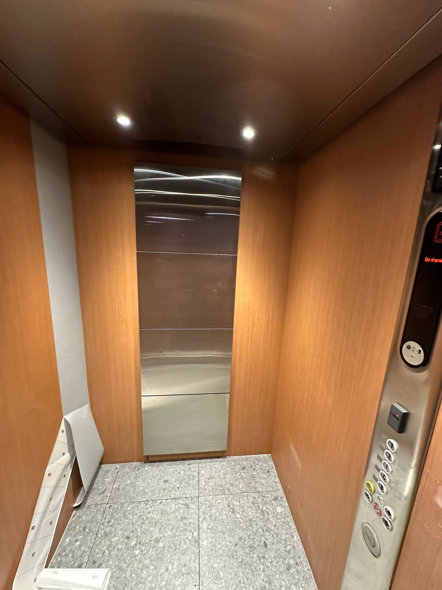 Before: Lift car, timber veneer to grey linen