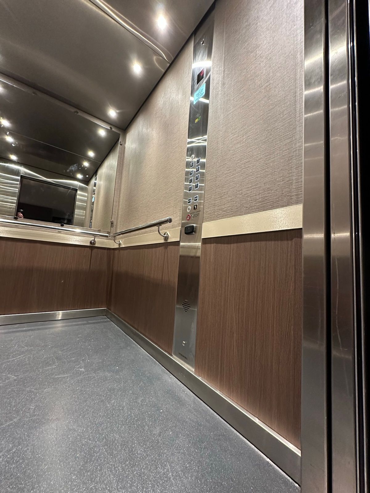 Installation in progress: Lift car, stainless to linen with a timber dado