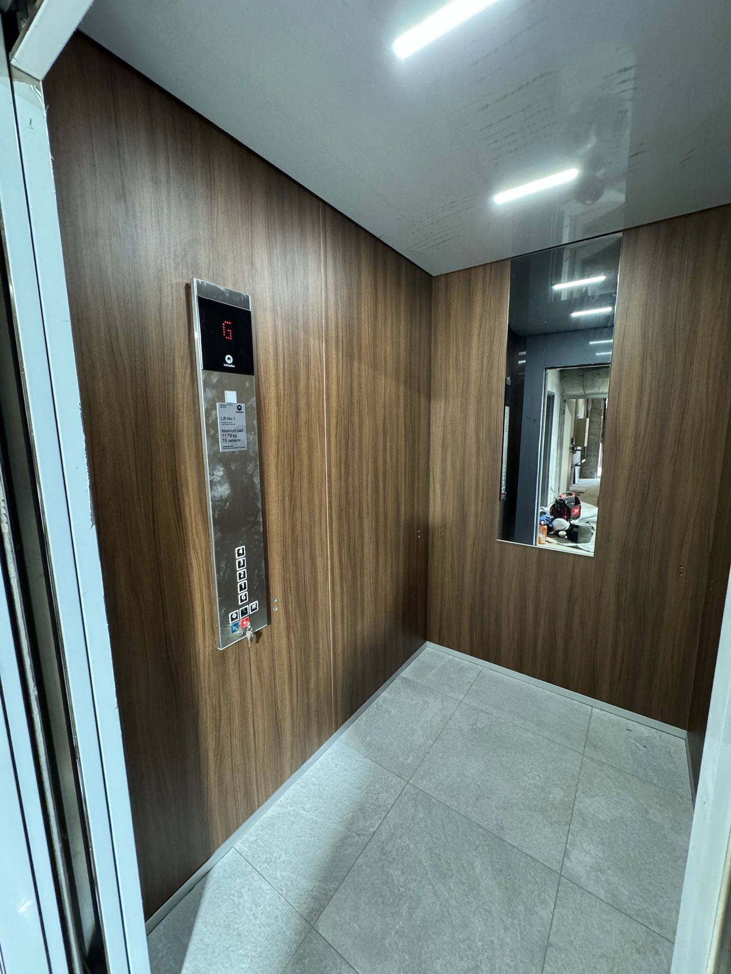 After: Lift car walls, white to warm woodgrain