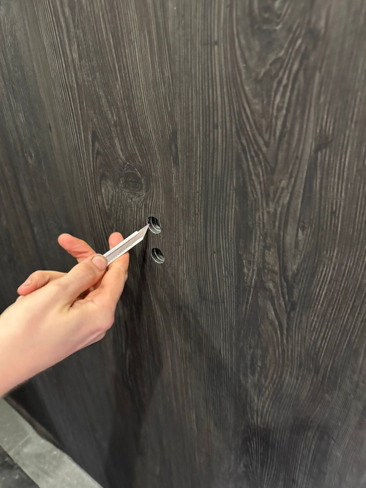 Installation in progress: Lift car, stainless to dark woodgrain