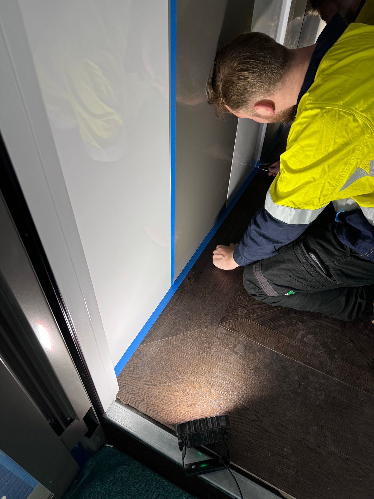 Installation in progress: Lift car, white gloss to textured charcoal