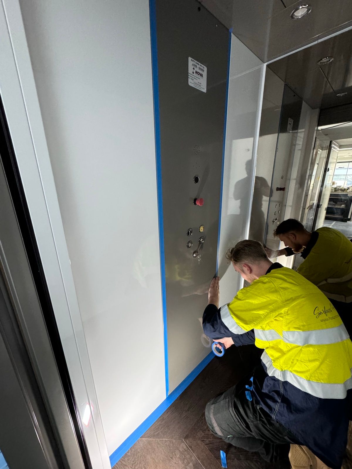 Installation in progress: Lift car, white gloss to textured charcoal