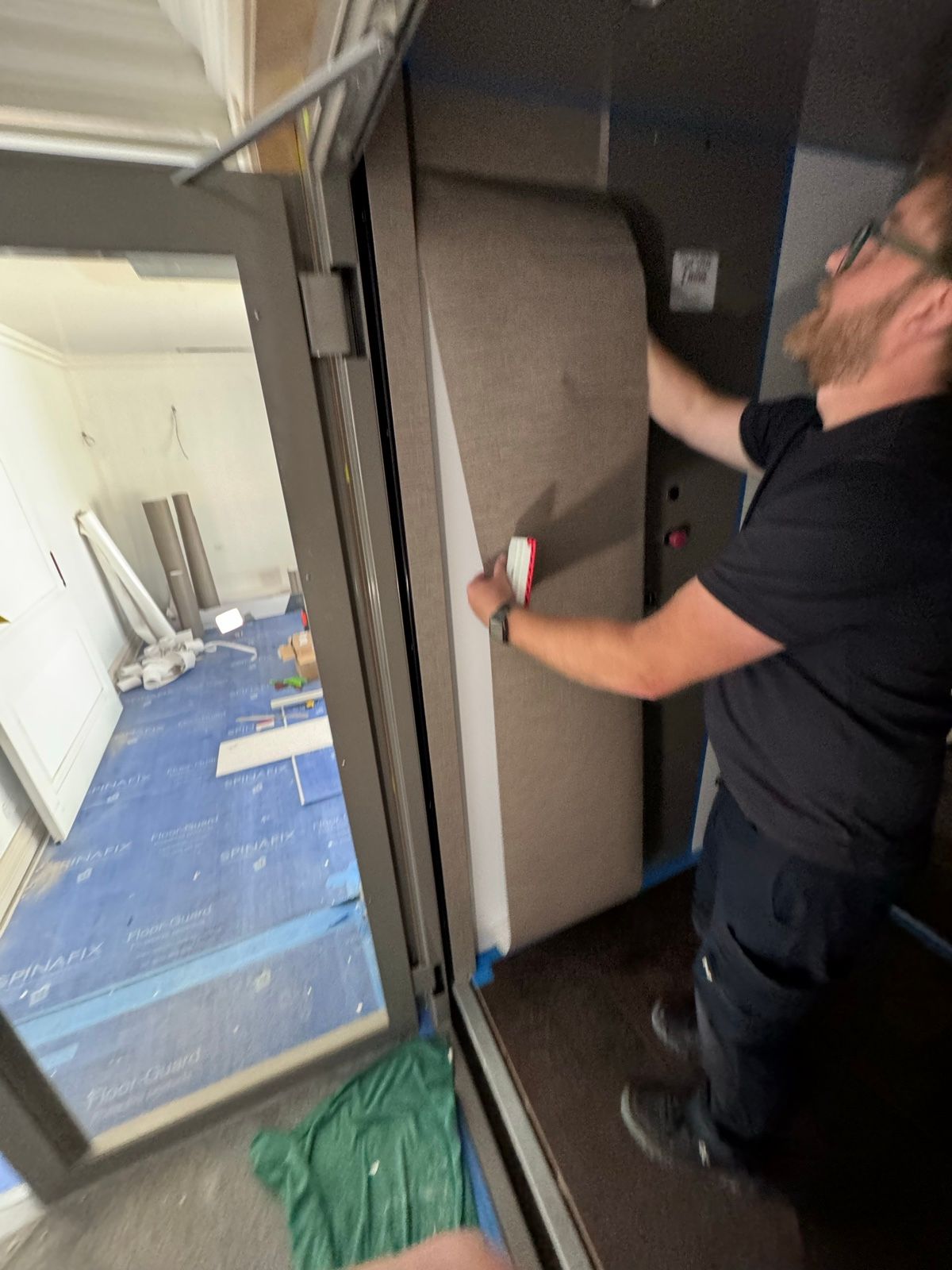 Installation in progress: Lift car, white gloss to textured charcoal