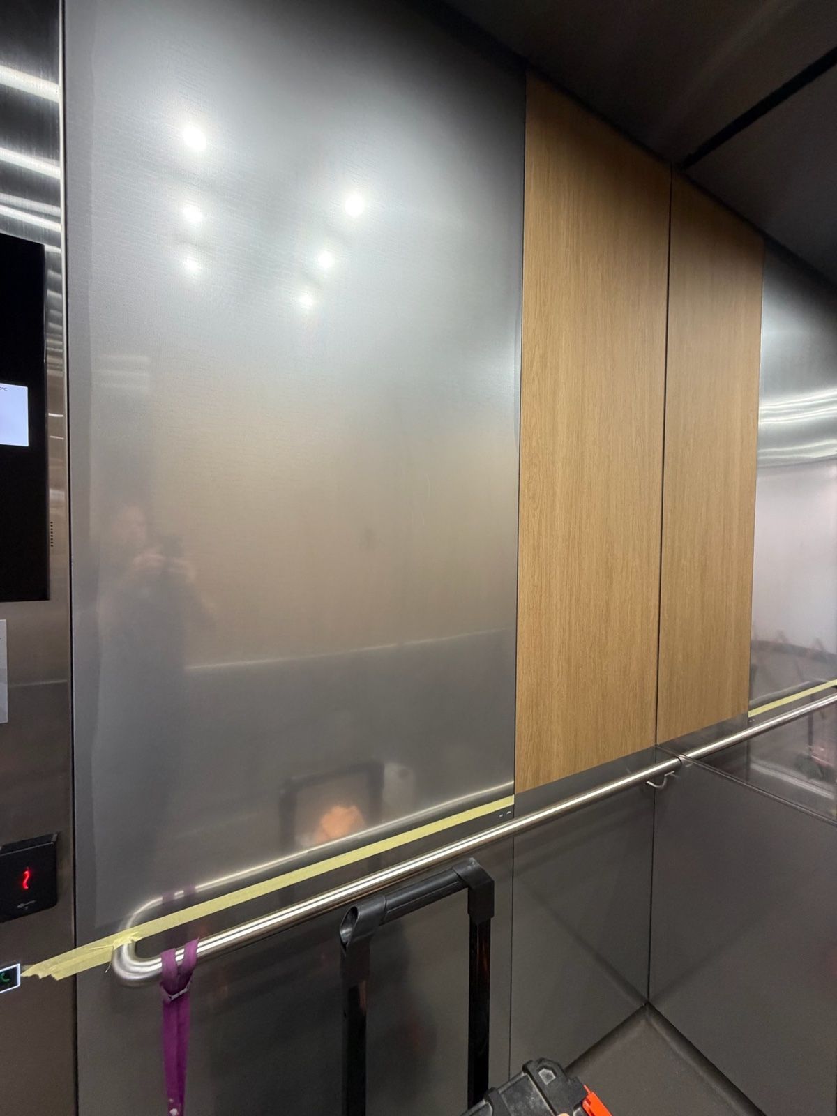 Installation in progress: Lift car, stainless to light woodgrain