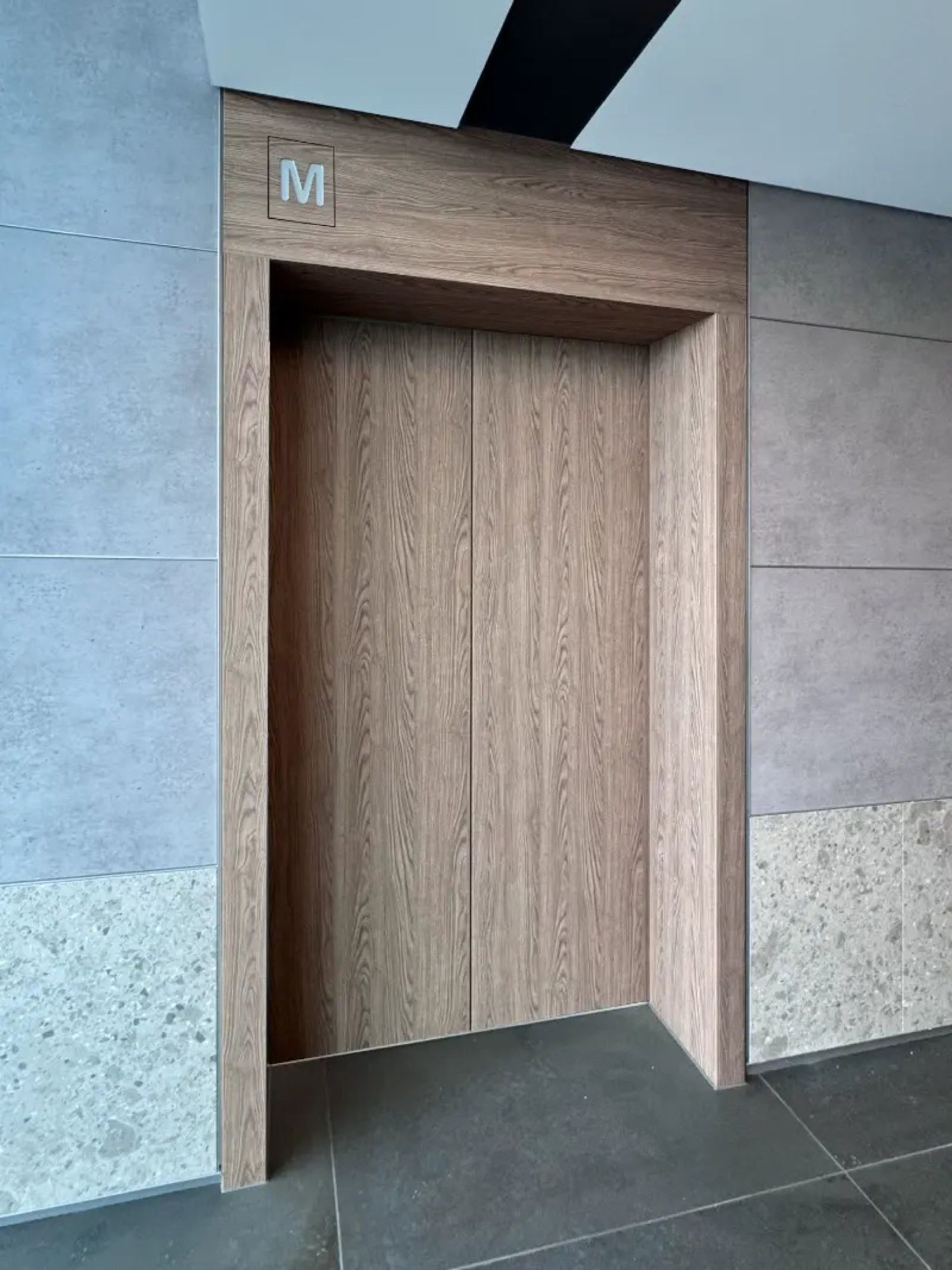 Lift doors and frame finished in timber woodgrain