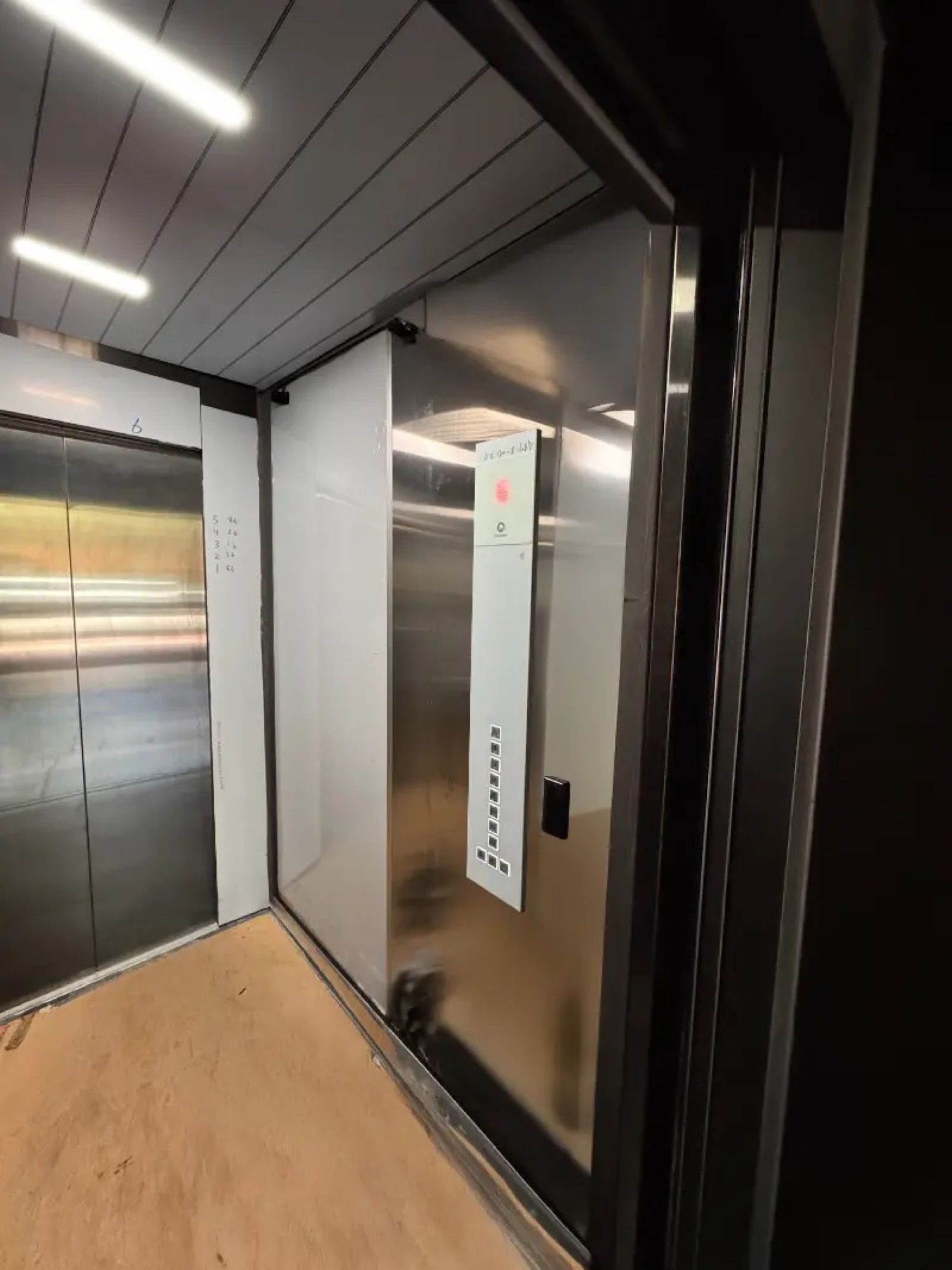 Before: Lift car walls, unfinished to dark woodgrain